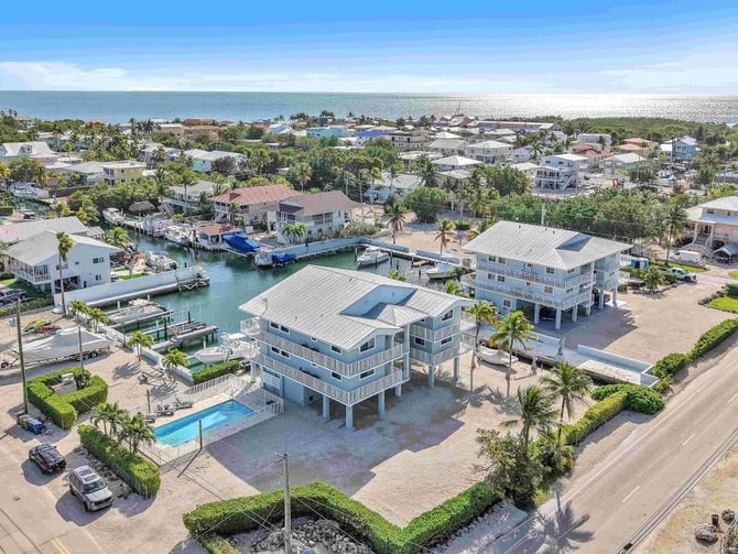 Aerial view of Ocean Shore Villas in Key Largo with pool, docks, and ocean